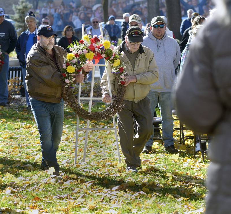 Hank Walsh and 103 years old World War ll veteran Francis Killelea carry one of the three memorial wreaths Saturday, Nov. 11, 2023, during the Veterans Day ceremony at Washington Square in Ottawa. The Ottawa Memorial Association hosted the event.