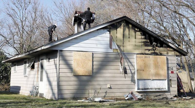 Workers secure the scene of a fatal fire that took place early the morning of Wednesday, Nov. 23, 2022, in the 700 block of Papoose Road in Carpentersville.