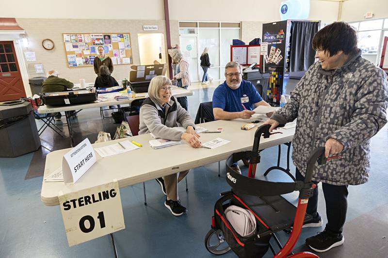 Roberta Dillon steps up to vote at precinct one judged by Olivia Wade and Chad Hammer Tuesday, April 4, 2023 at the mall in Sterling.