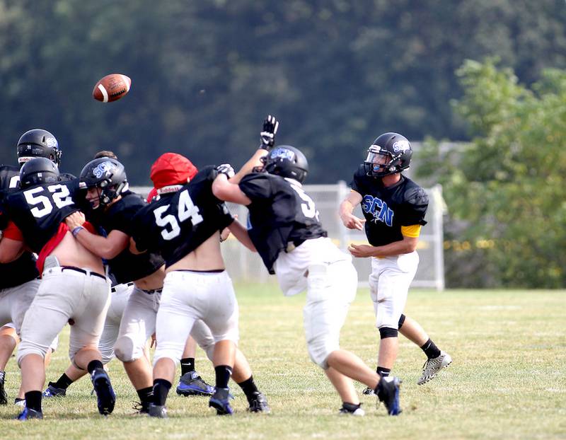 St. Charles North quarterback Zach Mettatal (far right) throws the ball during practice at the school Tuesday. The North Stars got off to a fast start in Week 1 with a 30-point first half, but a full 48 minutes will be key as they head on the road to Bartlett in Week 2.