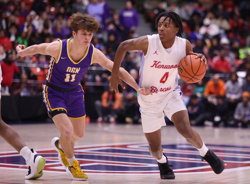 Kenwood Academy's Darrin Ames (4) tries to drive past Downers Grove North's Owen Thulin (11) during the boys 4A super-sectional game between Kenwood Academy and Downers Grove North high school in Chicago on Monday, March 6, 2023.