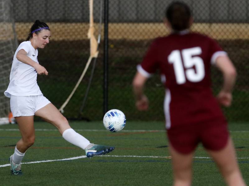 Hampshire's Shayne Norris kicks the ball in front of Prairie Ridge's Olivia Mcpherson during a Fox Valley Conference soccer game on Tuesday, April 16, 2024, at the MAC Athletic Complex in Crystal Lake.