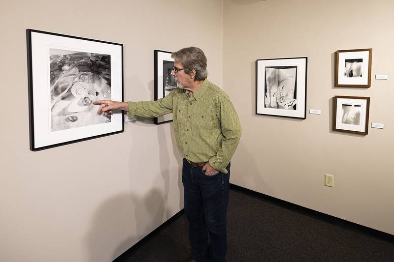 Photographic artist Les Allen points out objects in one of his works on display Tuesday, Oct. 7, 2025. The show will be up until Nov. 20 in the second-floor, east-end art gallery at Sauk Valley Community College in Dixon.