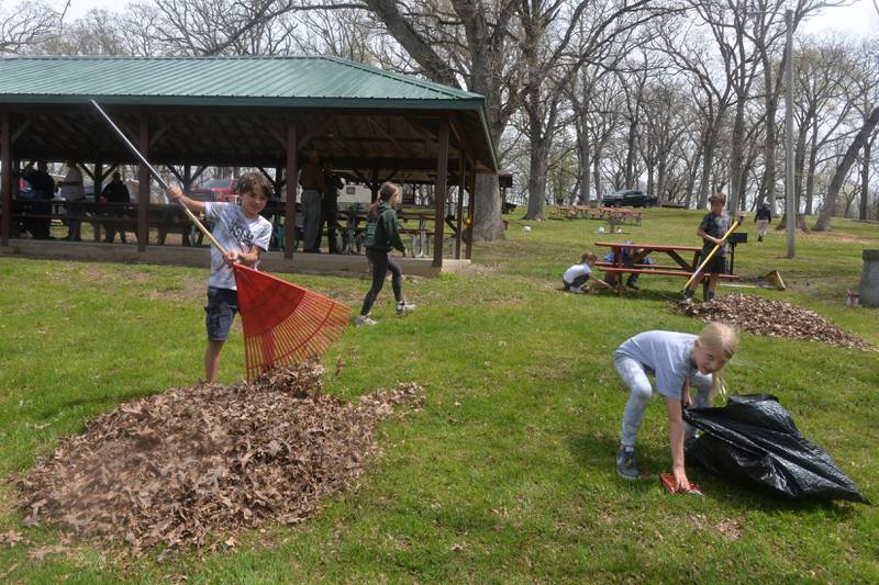 It was a group effort on Friday, April 28 when Ogle County residents and county officials worked together to clean up Weld Park, the county's only park. Here, Quade and Madeline Hogan rake leaves and pickup debris.
