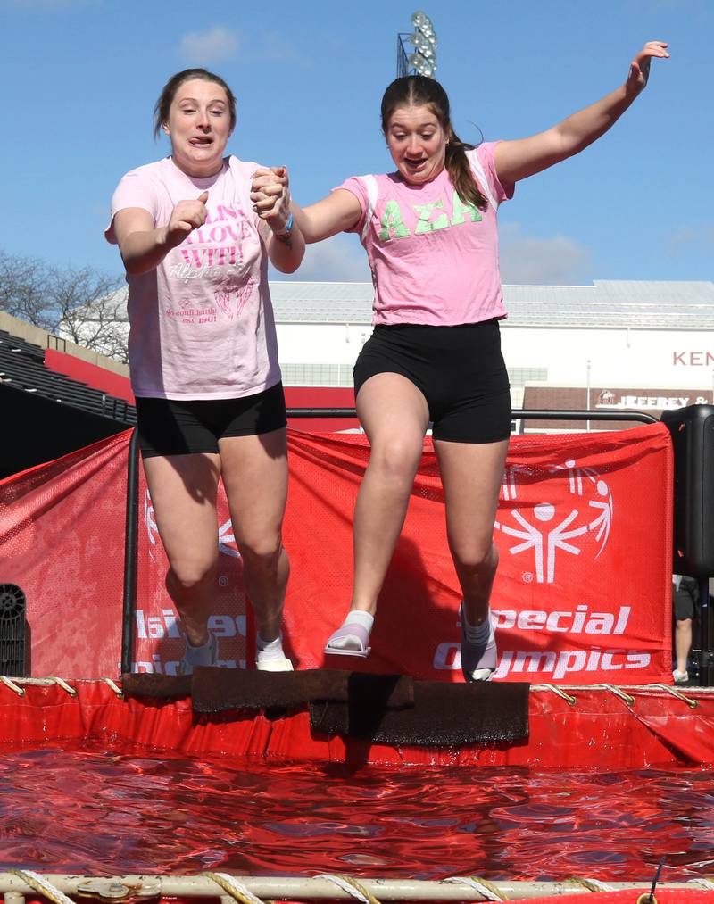 Members of the Alpha Sigma Alpha sorority jump into the water on a cold and windy Saturday, Feb 17, 2024, during the Huskie Stadium Polar Plunge at Northern Illinois University in DeKalb. The Polar Plunge is the signature fundraiser for Special Olympics Illinois.