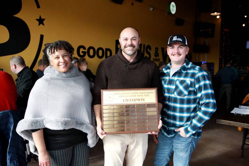 (From left) City of St. Charles Lab Supervisor Christina Smith, St. Charles Public Works Division Manager - Water Matt Wilson and Garett Guthrie, division manager-wastewater, with the plaque after the city won the annual Kane County Water Association's annual water tasting contest at Global Brew in St. Charles.