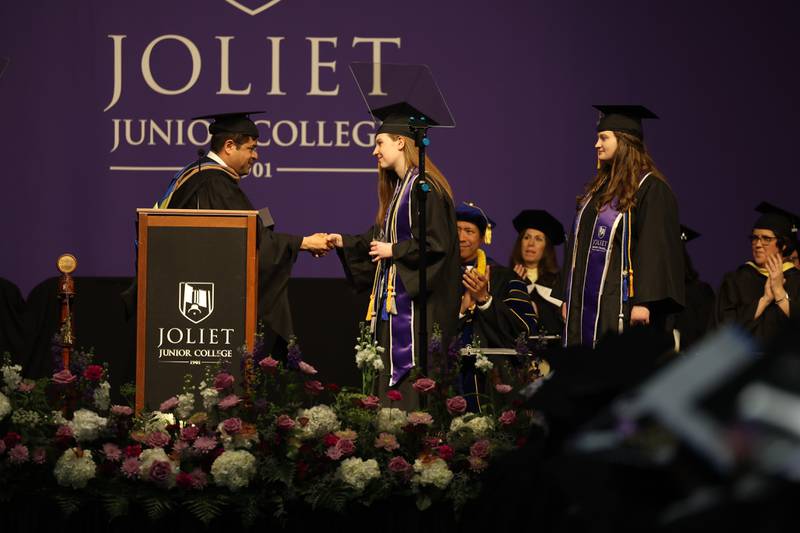 Sydney Reppy, center, and her twin sister, Emily, receive the Student Service Recognition Award at the Joliet Junior College Commencement Ceremony on Friday, May 19, 2023, in Joliet.