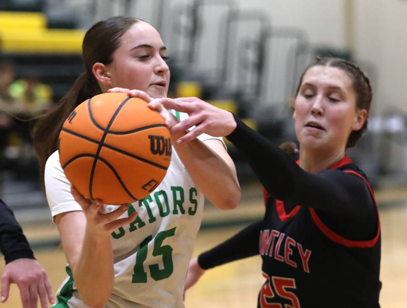 Crystal Lake South's Tessa Melhuish grabs a rebound in front of Huntley's Evelyn Freundt during a Fox Valley Conference girls basketball game on Friday, Jan. 30, 2026, at Crystal Lake South High School.