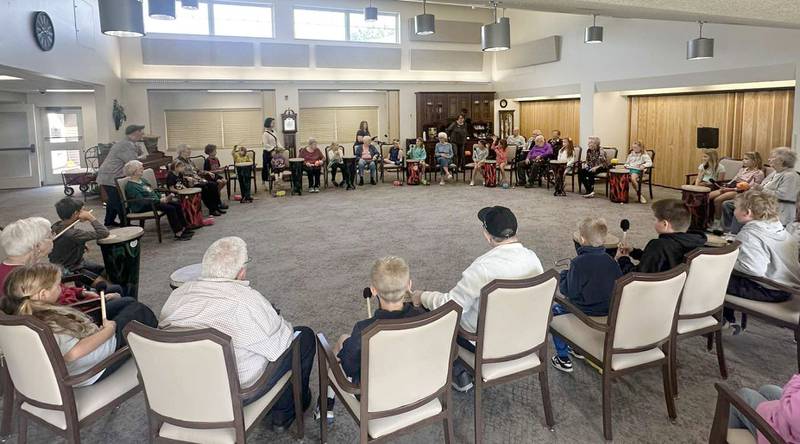 Lincoln Elementary School students play a drum circle with Greenfield residents on Friday, Oct. 17, 2025 at Greenfield Retirement Home in Princeton. The drum circle was hosted by Eric Swanson of Chicago, through his business Drum Impact. The students learned how to make rhythm, play instruments, music therapy, collaboration and converse with the residents.