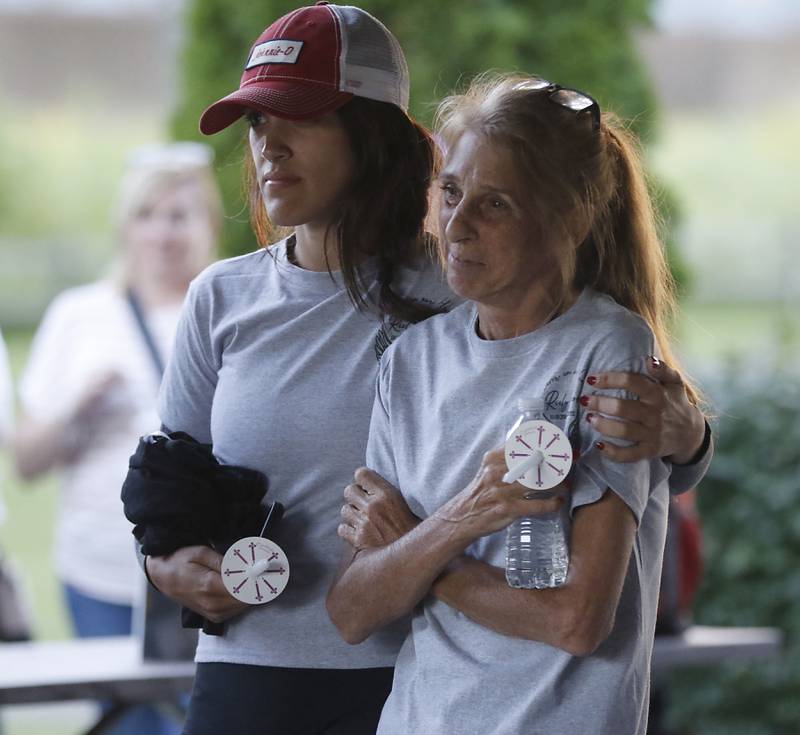 Jackie Teuerle, right is comforted by family friend Alexandria Rayappa, left, during a candlelight celebration for her son, Riely Teuerle, on Thursday, August 11, 2022, at Towne Park, 100 Jefferson Street in Algonquin. Teuerle was killed in a car crash in Lake in the Hills on Tuesday. Over 100 family members and friends gathered at the park to remember and celebrate Teuerle’s life.