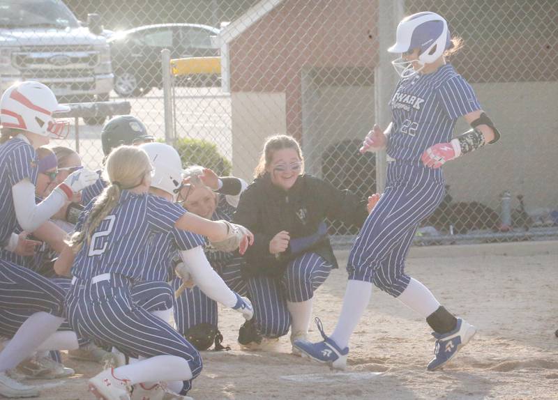 Newark's Mandy Winninger steps on home plate while being greeted by teammates after hitting a home run against Earlville during the Class 1A Regional final on Thursday, May 22, 2025 at Indian Creek High School in Shabbona.