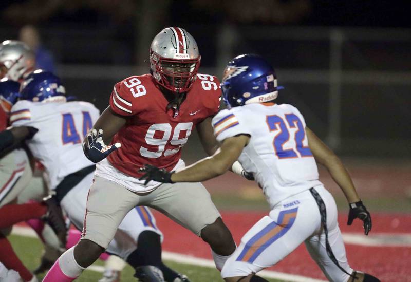 Palatine's Jaylen Williams (99) blocks Hoffman Estates' Julian Bonilla, (22) Friday October 21, 2022 in Palatine.