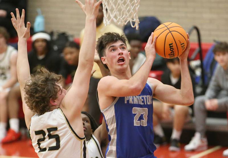 Princeton's Noah LaPorte eyes the hoop as Oak Forest's Hayden Noha defends during the Dean Riley Shootin' The Rock Thanksgiving Tournament on Tuesday, Nov. 26, 2024 in Kingman Gym at Ottawa High School.