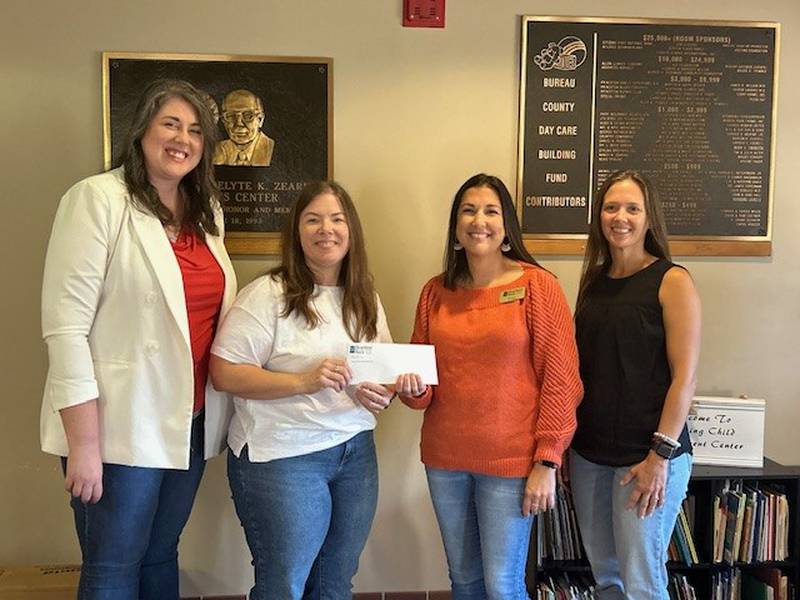 (From left) Chariss Hoffman, Heartland Bank Princeton South; Nicole Sampson, assistant director of Zearing Child Enrichment Center; Jessica Peterson, Princeton South; Mary Brown, assistant director of Zearing Child Enrichment Center pose for a recent donation presentation.