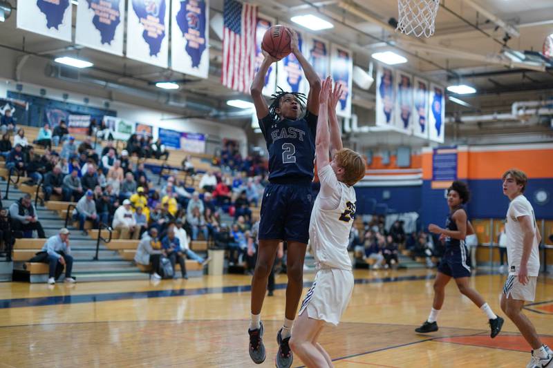 Oswego East's Mason Lockett IV (2) shoots the ball in the post over Neuqua Valley's Colin Gerrity (24) during a hoops for healing basketball tournament game at Oswego High School on Friday, Nov 24, 2023.