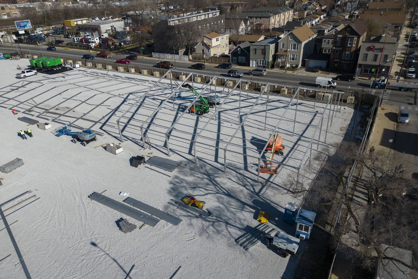 Construction of a government-run tent encampment for migrants is underway Wednesday, Nov. 29, 2023, in the Brighton Park neighborhood of Chicago.