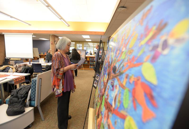 People including Senior Pastor of 1st United Methodist of LaGrange, Cerna Castro Rand look over historical images to see what emotional connection they may have as part of the breakout sessions during the Building Inclusive Community Conference held at Lyons Township Saturday, Feb. 8, 2025.