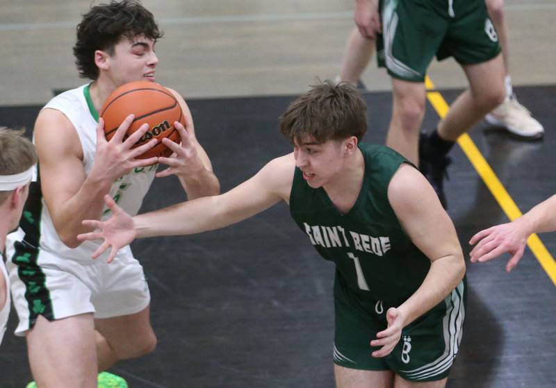 Seneca's Kysen Klinker grabs a loost ball in the lane as St. Bede's Halden Hueneburg arrives late to the ball during the Tri-County Conference Tournament on Tuesday, Jan. 23, 2024 at Putnam County High School.