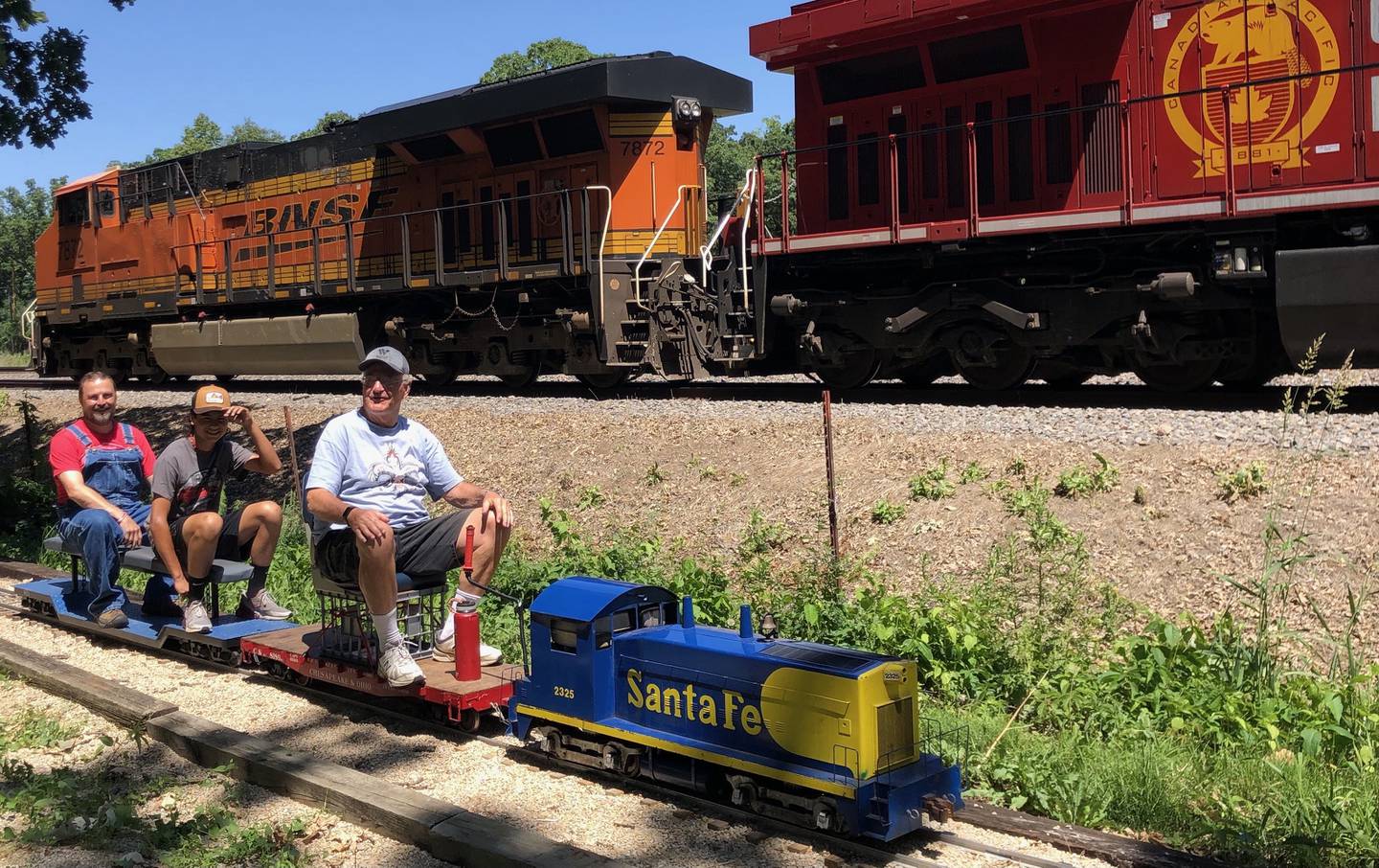 George Werderich with his father Wally Werderich and grandfather George A. Werderich riding their 7.5 gauge train on the Prairie State Railroad in Plowman's Park. (photo provided)