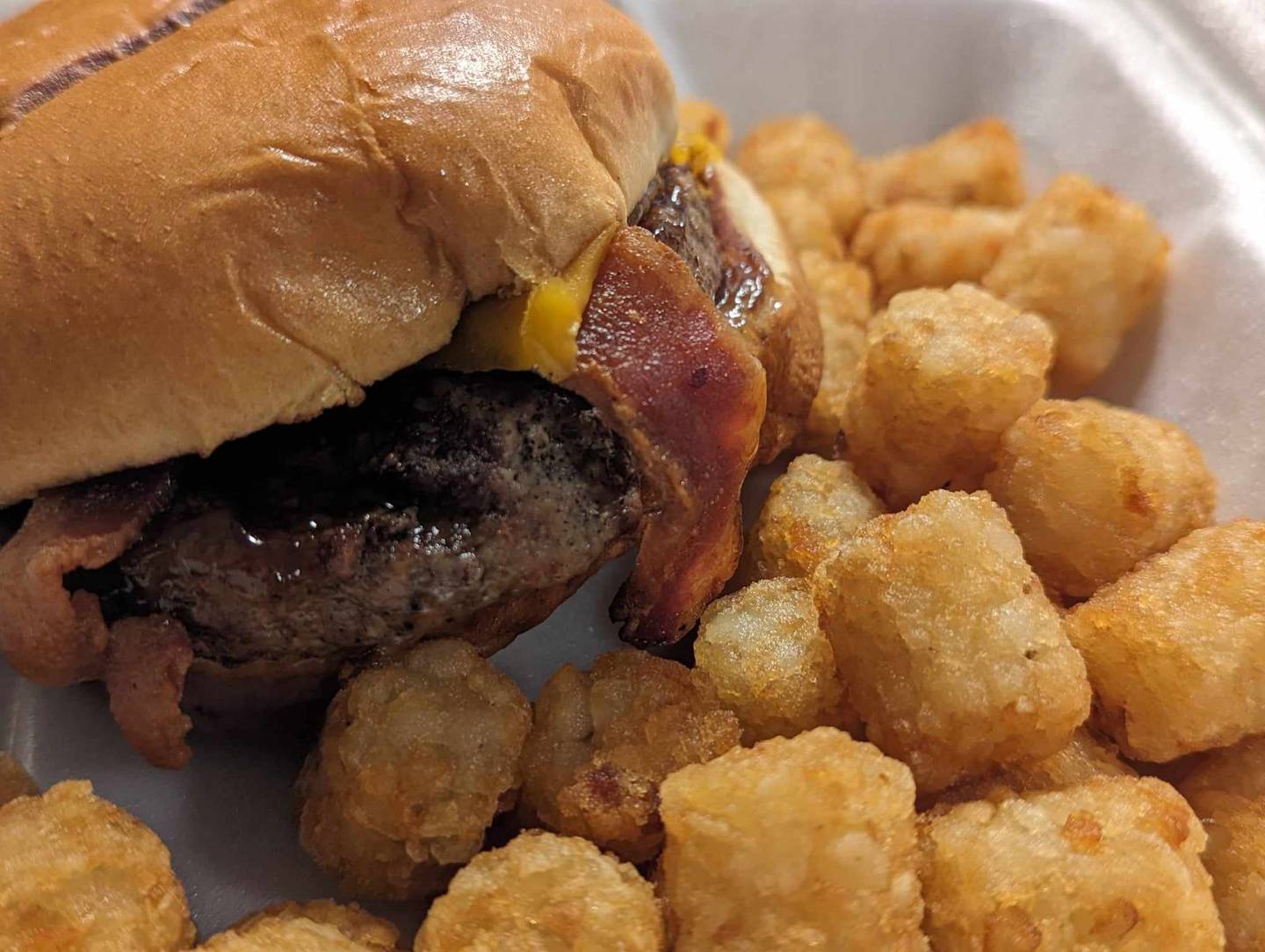 The bourbon barrel burger for $12 at Backroads Burger & Bar in Plainfield came generously topped with sharp Cheddar cheese, house-made bourbon glaze, applewood bacon, shredded lettuce and sautéed onions. The tater tots were crispy on the outside and soft and potatoe-y on the inside.