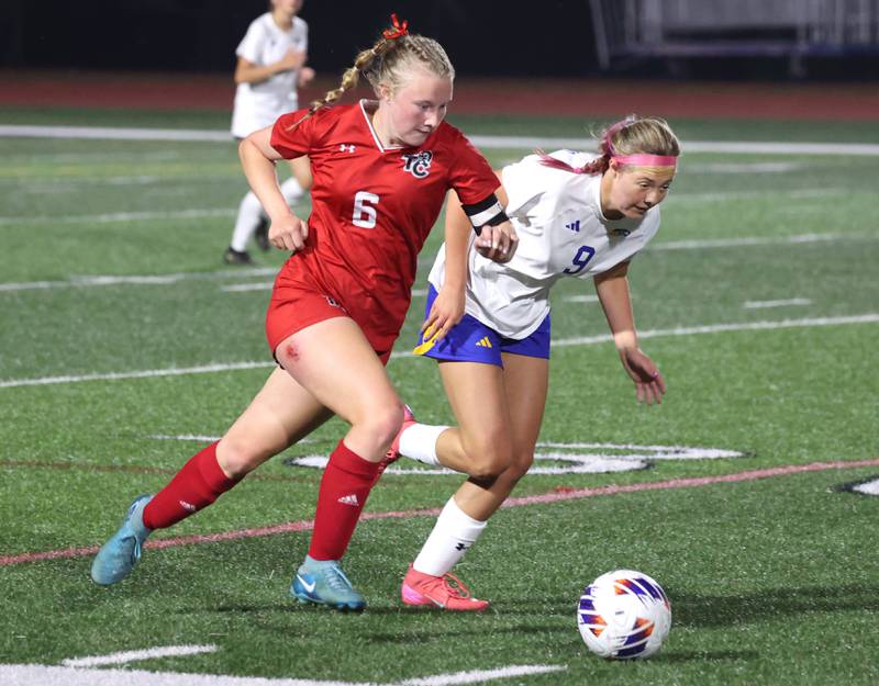 Timothy Christian's Mia Schilf (left) and Johnsburg's Brooke Butler go after the ball Thursday, June 5, 2025, during their IHSA Class 1A state semifinal game at North Central College in Naperville.