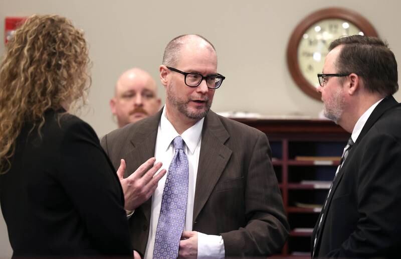 Jonathan Hurst (center) talks to his attorneys Thursday, Jan. 23, 2025, during his trial at the DeKalb County Courthouse in Sycamore. Hurst is charged in the 2016 slayings of Sycamore elderly mother and son Patricia and Robert Wilson.