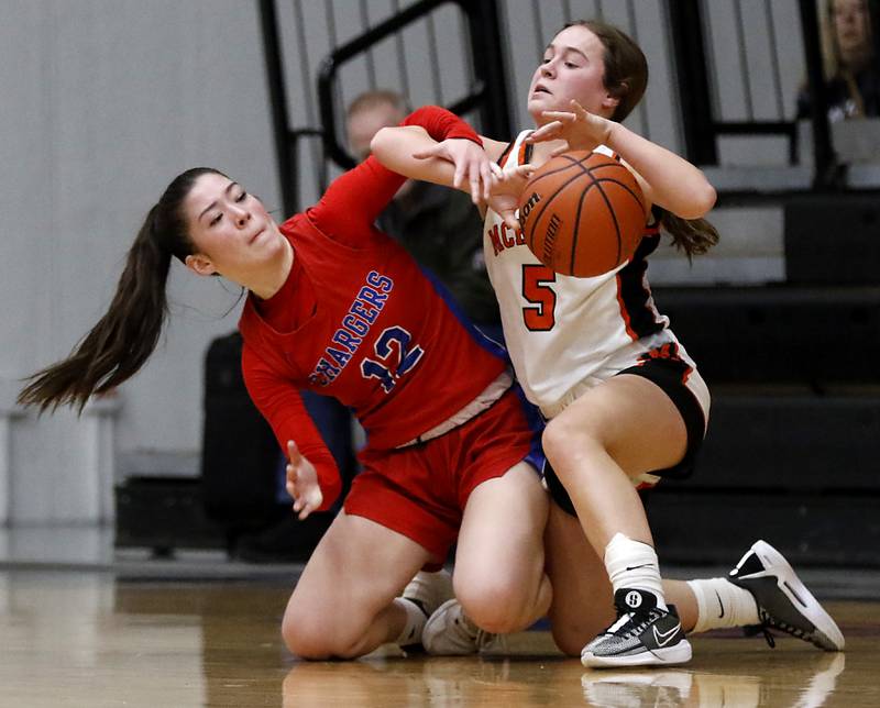 Dundee-Crown’s Charlotte Stewart battles with McHenry's Gaby Grasser for control of the basketball during a Fox Valley Conference girls basketball game on Tuesday, Dec. 12, 2023, at McHenry High School.