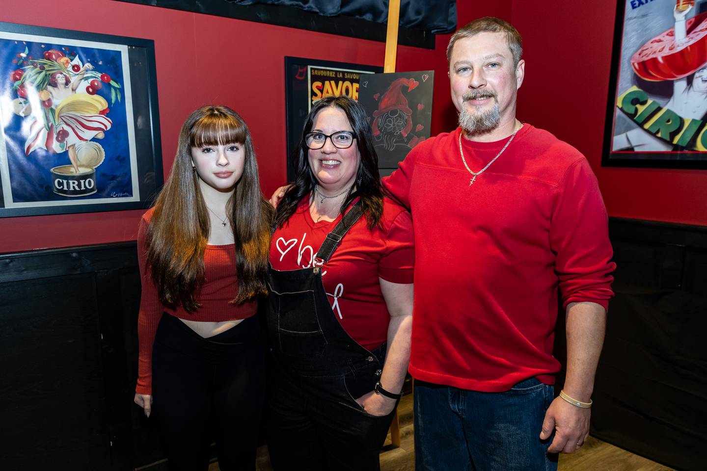 Divine Design Paint Studio owner and artist, Annie Flint, takes a photo with her daughter, Isabella, and husband, Bob, at Papa Joe's in Lockport on Feb. 6, 2025.