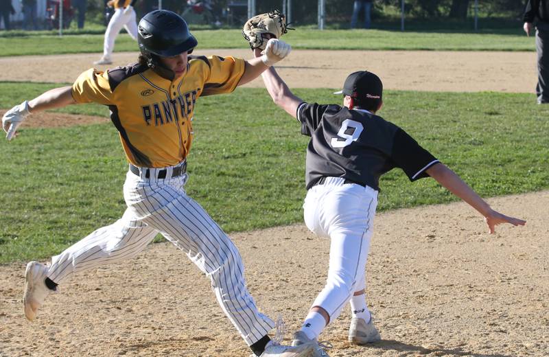 Putnam County's Jonathon Stodard is called out at first base as Woodland/Flanagan-Cornell's Sam Schmitz makes the squeeze on Tuesday, April 9, 2024 at Woodland High School.