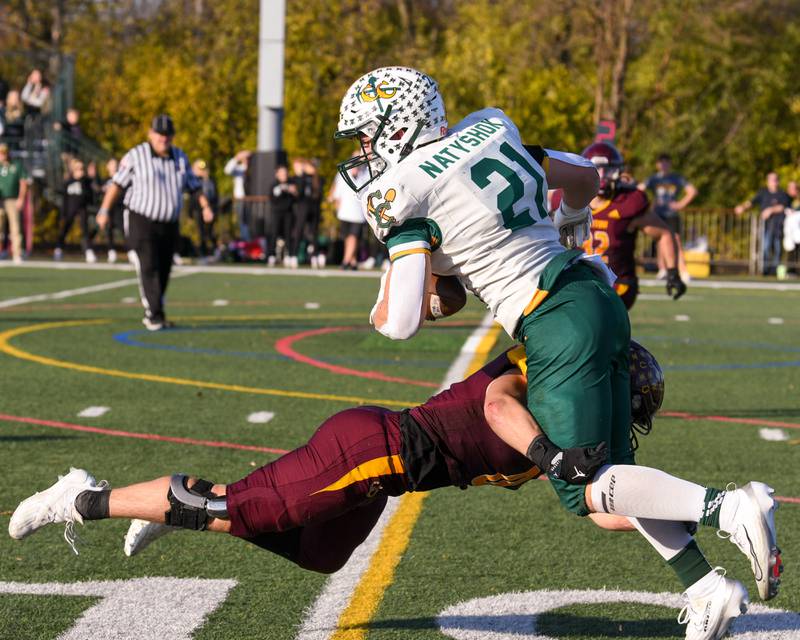 Coal City's Logan Natyshok, right, tries to dodge Montini Catholic's defender Laddie Asay (0) to gain extra yards during the 4A quarterfinals game on Saturday Nov. 15, 2025, held at Montini Catholic High School.
