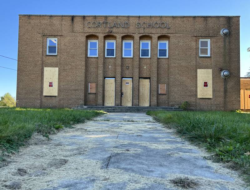 The old Cortland Elementary School stands with its windows boarded up on Oct. 1, 2022.
