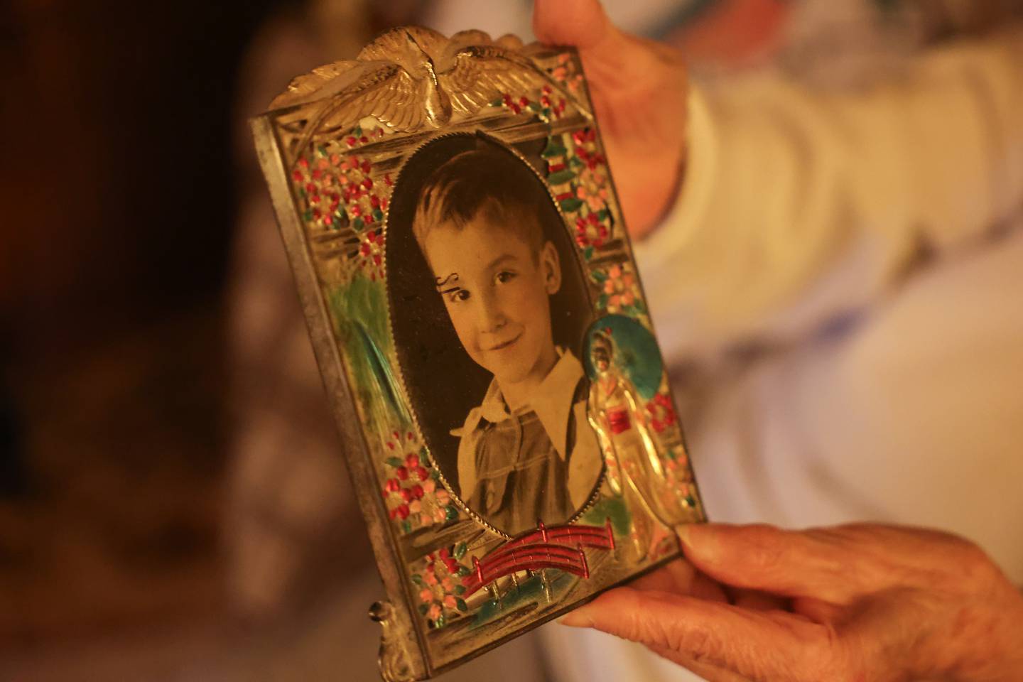 Barbara Lee Cerney hold a photo of a young Bryan Myers Jr. in a frame that he bought while serving tour in Japan at her home in Shorewood on Friday, May 24, 2024. PFC Bryan Myers Jr’s remains were recently returned to family after being kill in Korea in 1950.