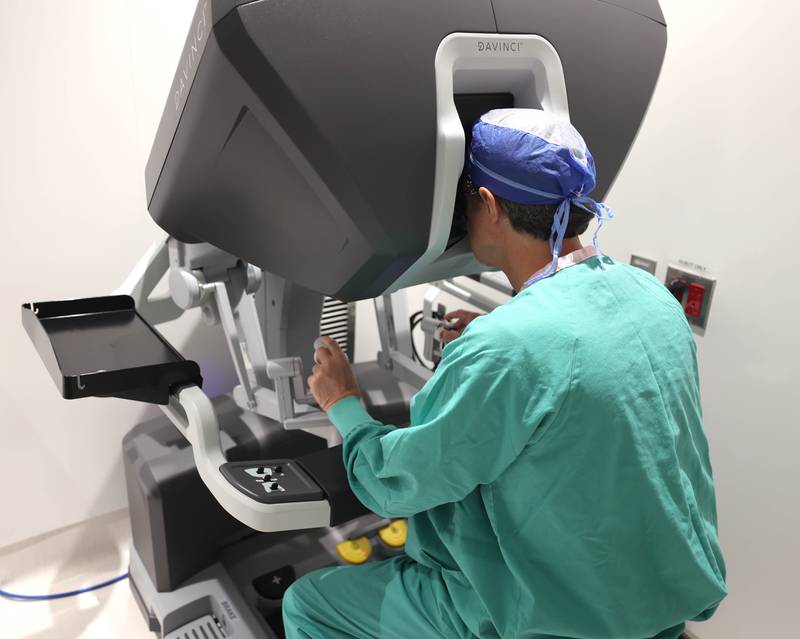 Dr. Jack Wagoner, associate chief medical officer at Northwestern Medicine Kishwaukee Hospital, sits at the controls of the da Vinci Xi robotic surgical system Tuesday, Oct. 28, 2025, in one of the operating rooms at the hospital in DeKalb. The hospital recently celebrated its 2,000th successful robotic-assisted surgery.
