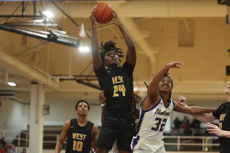 Joliet West’s Michah McNair pulls in a rebound against Joliet Central on Saturday, Jan. 27th, 2024 in Joliet.