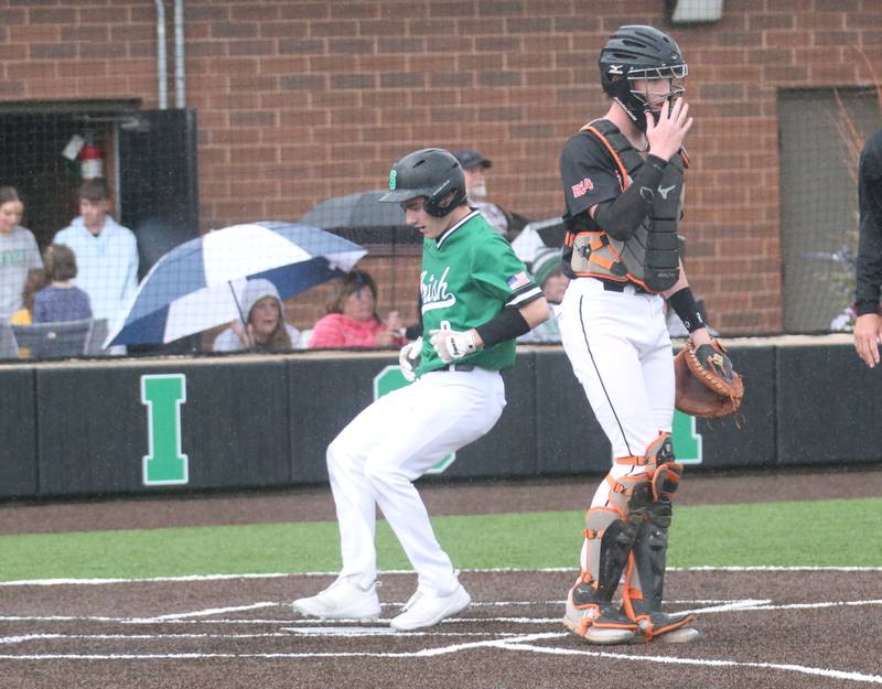Seneca's Griffin Hougas scores the teams first run as Roanoke-Benson/Lowpoint-Washburn catcher Leyton Harms waits for the late throw on Thursday, May 1, 2025 at Seneca High School.