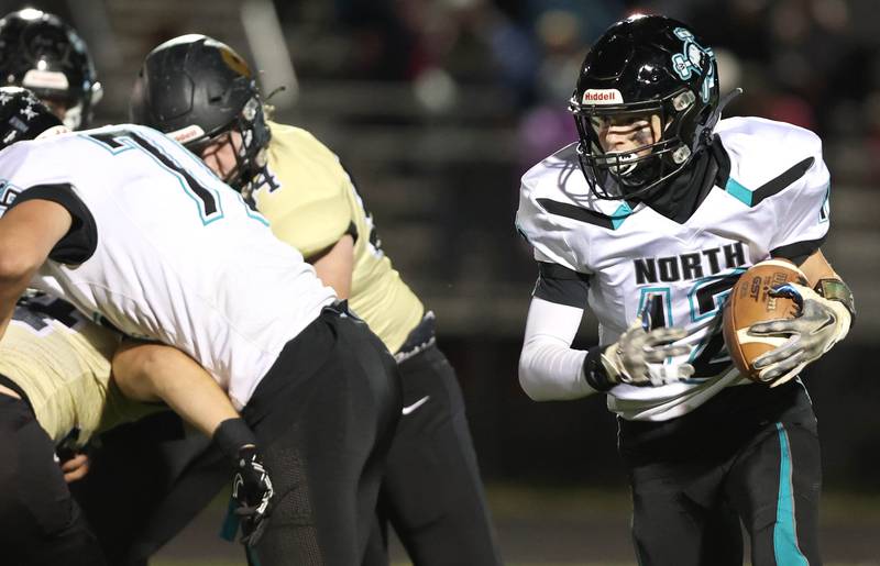 Woodstock North's Landan Creighton follows his blockers through the Sycamore defense during their game Friday Oct. 7, 2022, at Sycamore High School.