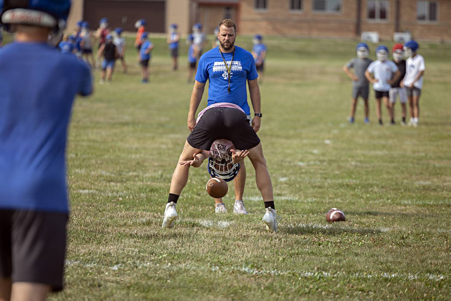 Newman players run through drills during first day of football practice Monday, August 7, 2023.