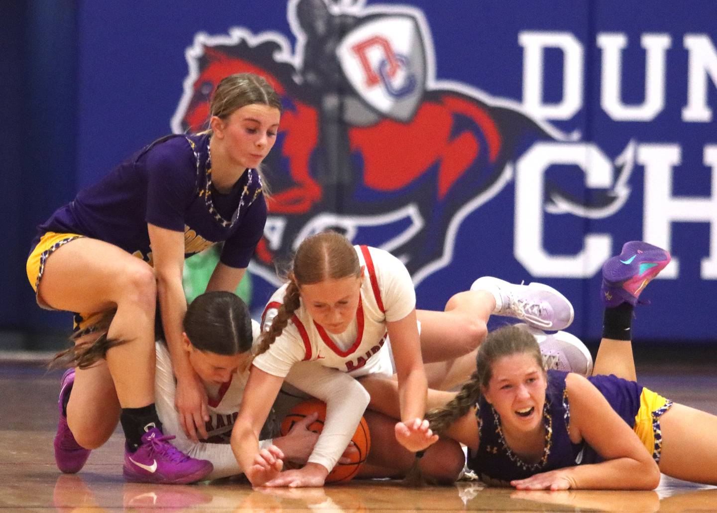 Huntley’s Evelyn Freundt, center left, and Avery Suess, center right, tussle with Hononegah’s Ainsley Hughes, left, and Addison Beilfuss, right, for the ball in girls basketball at Dundee-Crown High School in Carpentersville on Tuesday, November 25, 2025.