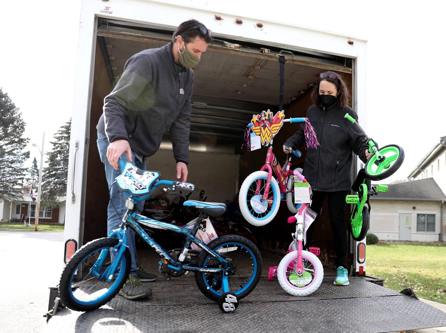 Tom and Jen Stopka unloads some of the toys they collected for donation to the Tri-City Salvation Army in honor of their son, Tommy