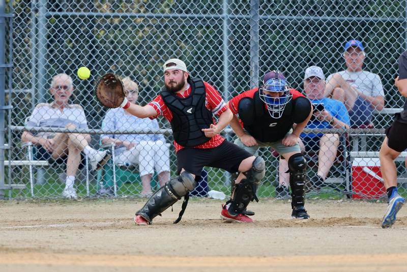 Malden Methodist catcher Colton Kuhne takes a throw to the plate during Tuesday's Princeton Park District's Fastpitch League championship game  at Westside Park.