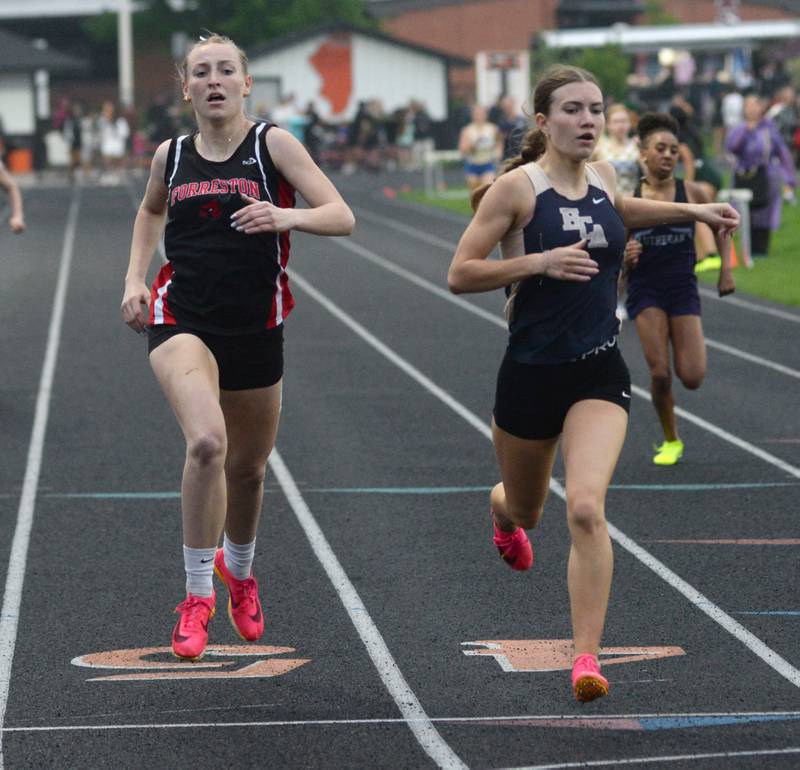 Forreston-Polo's Autum Pritchard (left) races Elgin Harvest Christian's Emma Leslie to the finish line in the 400 meters at the 1A Winnebago Sectional on Friday, May 12.