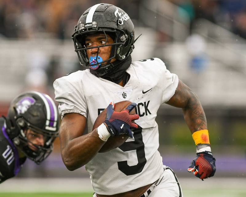Fenwick's Nate Marshall (9) runs the ball for a first down on Saturday Nov. 9, 2024, during the second week of the class 7A game while traveling to take on Downers Grove North High School.