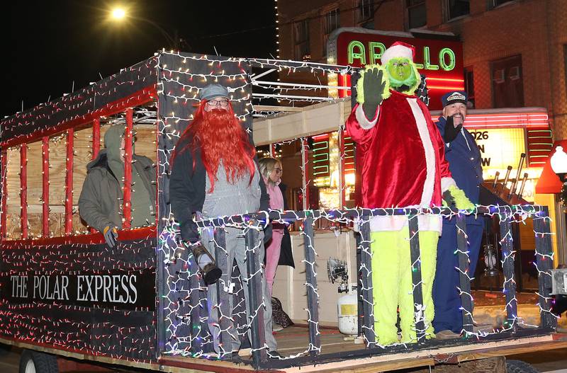 The Grinch rides the Polar Express float during the "Night of Lights" parade on Friday, Dec. 5, 2025 downtown Princeton. The event featured the Christmas tree lighting at Veterans Park a lighted Christmas parade down Main Street,  Living Windows, a Candy Cane Hunt, and visits with Santa.