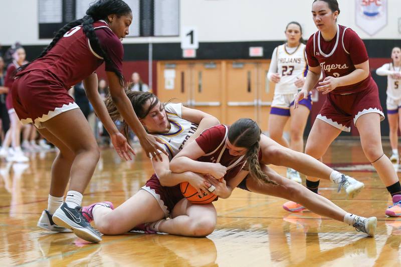 Downers Grove North's Adysen Fanta (15) fights for possession during their Regional Final basketball game between Downers Grove North at Plainfield North. Feb 20, 2025 in Plainfield.