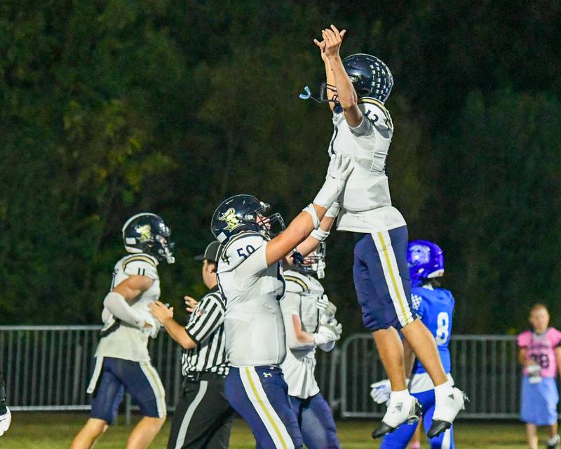 IC Catholic Prep's Landon West (59) lifts up his teammate Nate Lang (13) after a touchdown play during the game on Friday Oct. 3, 2025, while traveling to take on St. Francis High School.