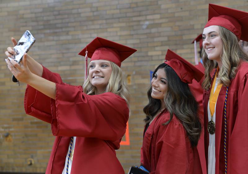 Natalie Williams takes a selfie of herself and friends Crystal Villalobos and Emily Kestner on Sunday, May 22, 2022, at Streator High School moments before entering Pops Dale gymnasium to receive her diploma.