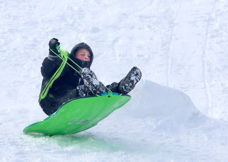 Bryce Niemic, 8, of Woodstock navigates the Emricson Park sledding hill in Woodstock Saturday in the wake of overnight snow.