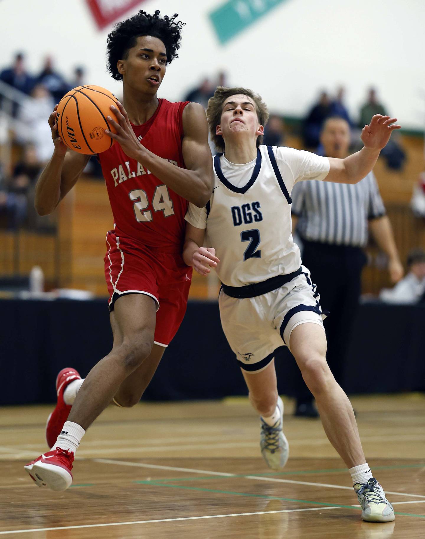 Palatine’s Abram Williams (24) collides with Downers Grove South’s Andrew Waterman (2) during the Jack Tosh Holiday Tournament Thursday, Dec. 26, 2024 at York High School in Elmhurst.