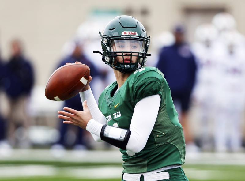 Lane Tech's Blake Perkins (4) looks for a receiver during the varsity football second-round 8A playoff game between Oswego and Lane Tech on Saturday, Nov. 8, 2025 in Chicago.
