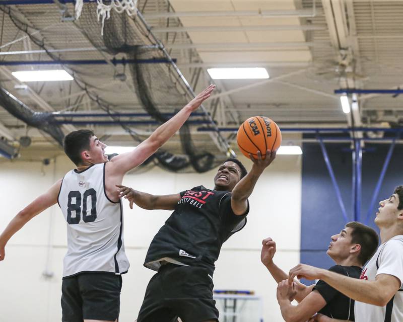 Glenbard East's Kaydin Benford Williams puts in a contested shot in their Riverside-Brookfield Shootout basketball game.  June 20, 2025 in Riverside.